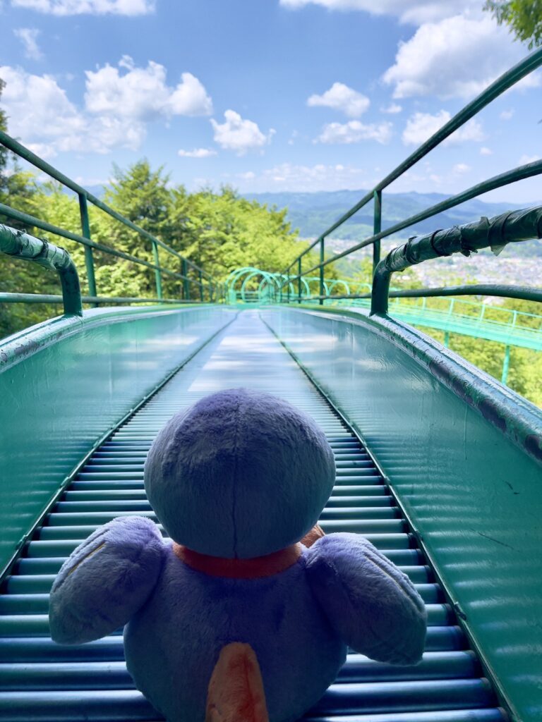 仙元山見晴らしの丘公園のローラーすべり台を滑ろうとするコバトン